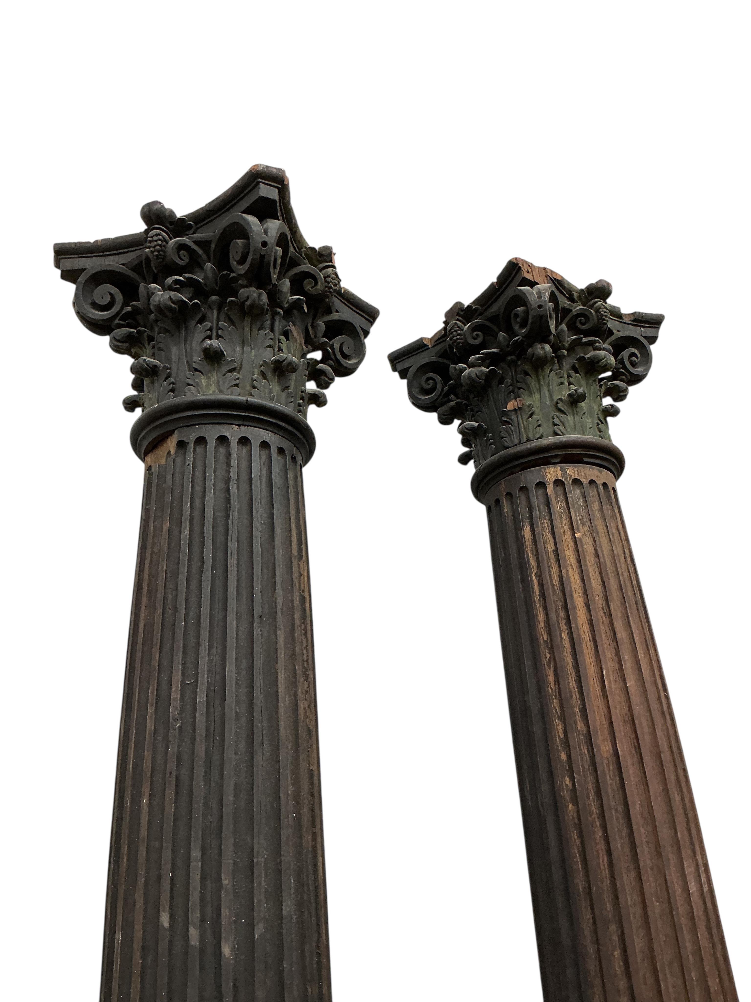A pair of 17th century oak Corinthian columns, of large size, height 279cm, from St Mary le Bow, designed by Christopher Wren